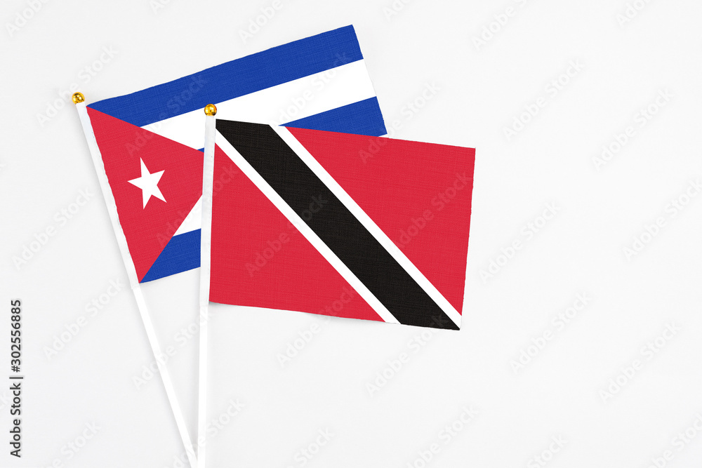 Trinidad And Tobago and Cuba stick flags on white background. High quality fabric, miniature national flag. Peaceful global concept.White floor for copy space. Trinidad And Tobago and Cuba stick flags on white background. High quality fabric, miniature national flag. Peaceful global concept.White floor for copy space.