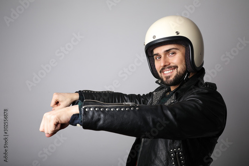 Portrait of biker with white helmet pretending ride his bike. Isolated.
