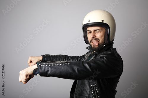 Portrait of biker with white helmet pretending ride his bike. Isolated.