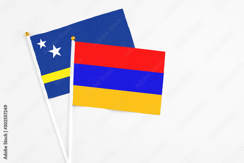 Armenia and Curacao stick flags on white background. High quality fabric, miniature national flag. Peaceful global concept.White floor for copy space. Armenia and Curacao stick flags on white background. High quality fabric, miniature national flag. Peaceful global concept.White floor for copy space.