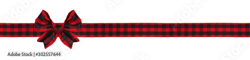 Red and black buffalo plaid Christmas gift bow and ribbon. Long border isolated on a white background.