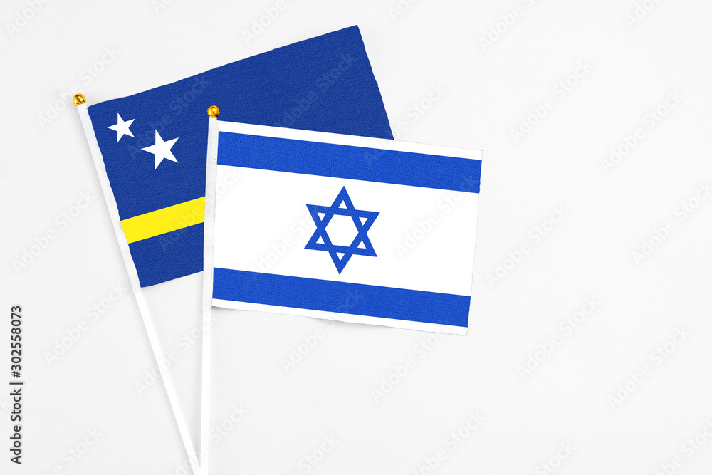 Israel and Curacao stick flags on white background. High quality fabric, miniature national flag. Peaceful global concept.White floor for copy space. Israel and Curacao stick flags on white background. High quality fabric, miniature national flag. Peaceful global concept.White floor for copy space.