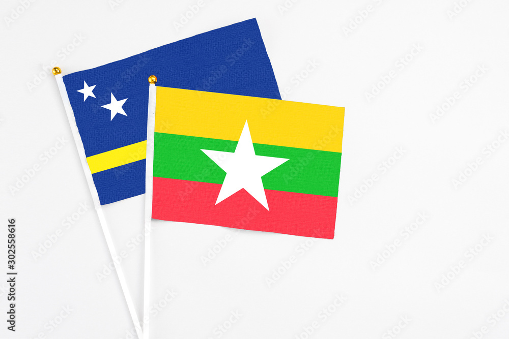 Myanmar and Curacao stick flags on white background. High quality fabric, miniature national flag. Peaceful global concept.White floor for copy space. Myanmar and Curacao stick flags on white background. High quality fabric, miniature national flag. Peaceful global concept.White floor for copy space.