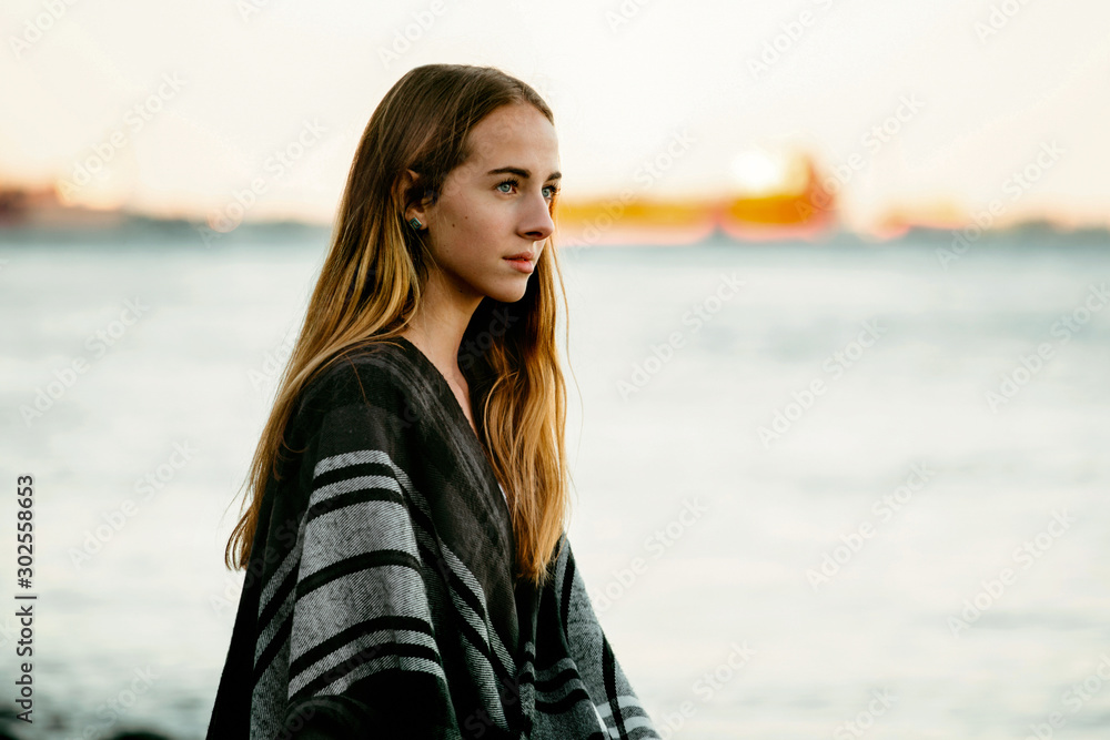 Portrait of Teenage girl looking out to a foggy lake. Portrait of Teenage girl looking out to a foggy lake.