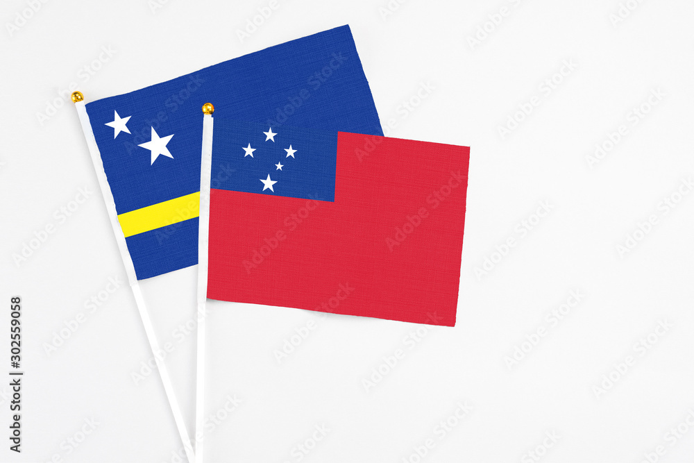 Samoa and Curacao stick flags on white background. High quality fabric, miniature national flag. Peaceful global concept.White floor for copy space. Samoa and Curacao stick flags on white background. High quality fabric, miniature national flag. Peaceful global concept.White floor for copy space.