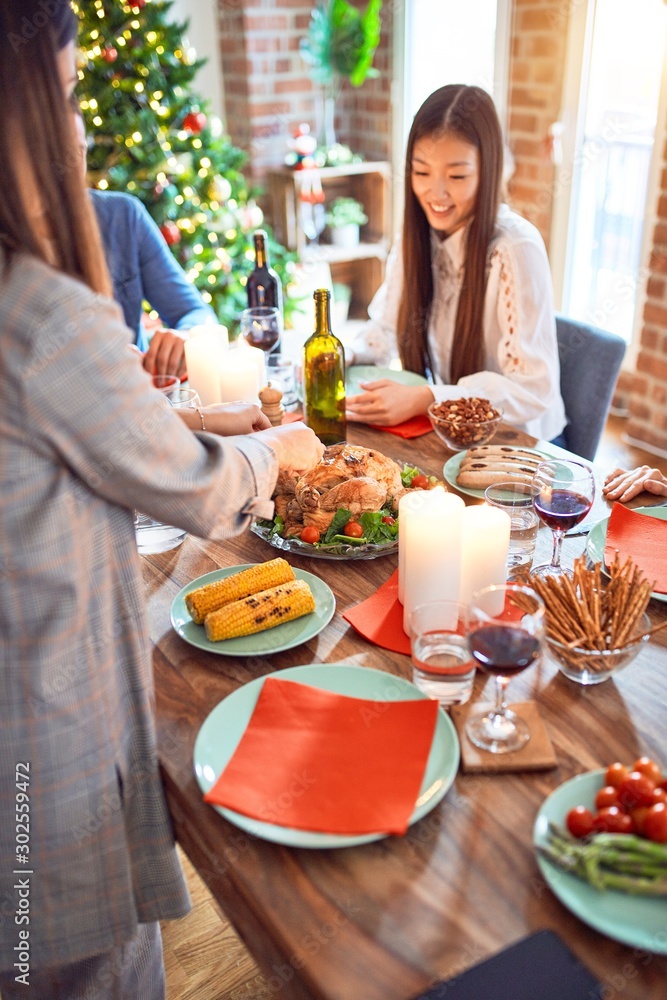 Beautiful family meeting smiling happy and confident. Carving roasted turkey celebrating Christmas at home Beautiful family meeting smiling happy and confident. Carving roasted turkey celebrating Christmas at home