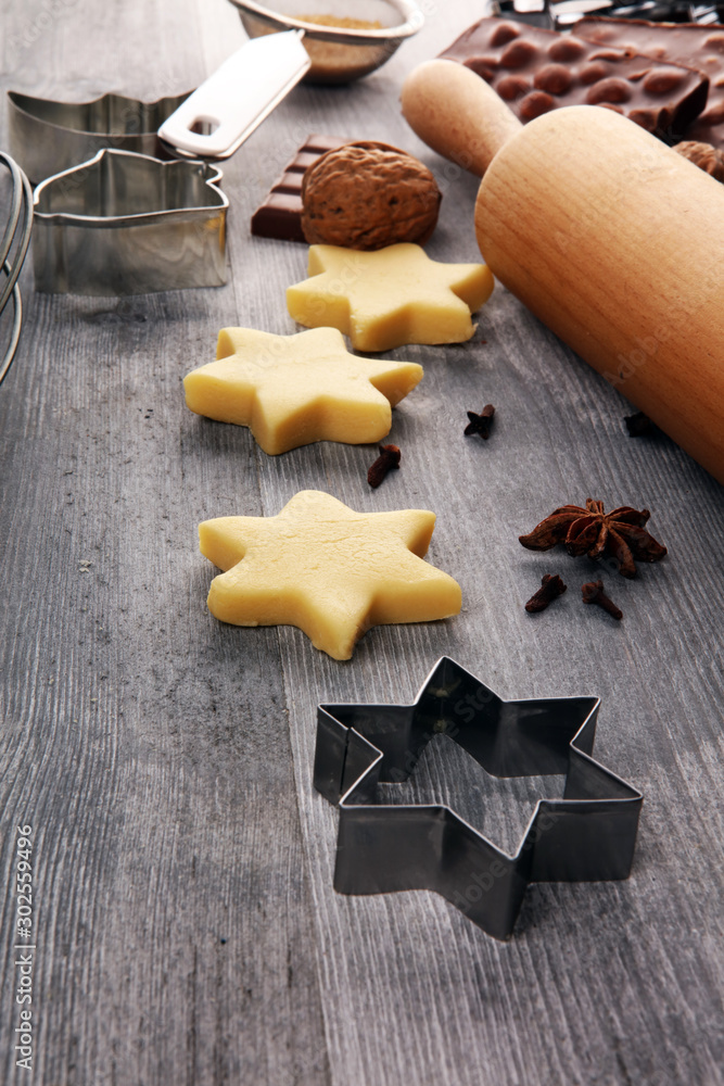 Baking christmas cookies. Typical cinnamon stars bakery with spices. xmas decoration on table Baking christmas cookies. Typical cinnamon stars bakery with spices. xmas decoration on table