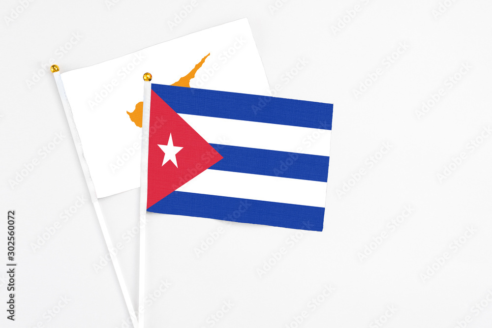Cuba and Cyprus stick flags on white background. High quality fabric, miniature national flag. Peaceful global concept.White floor for copy space. Cuba and Cyprus stick flags on white background. High quality fabric, miniature national flag. Peaceful global concept.White floor for copy space.
