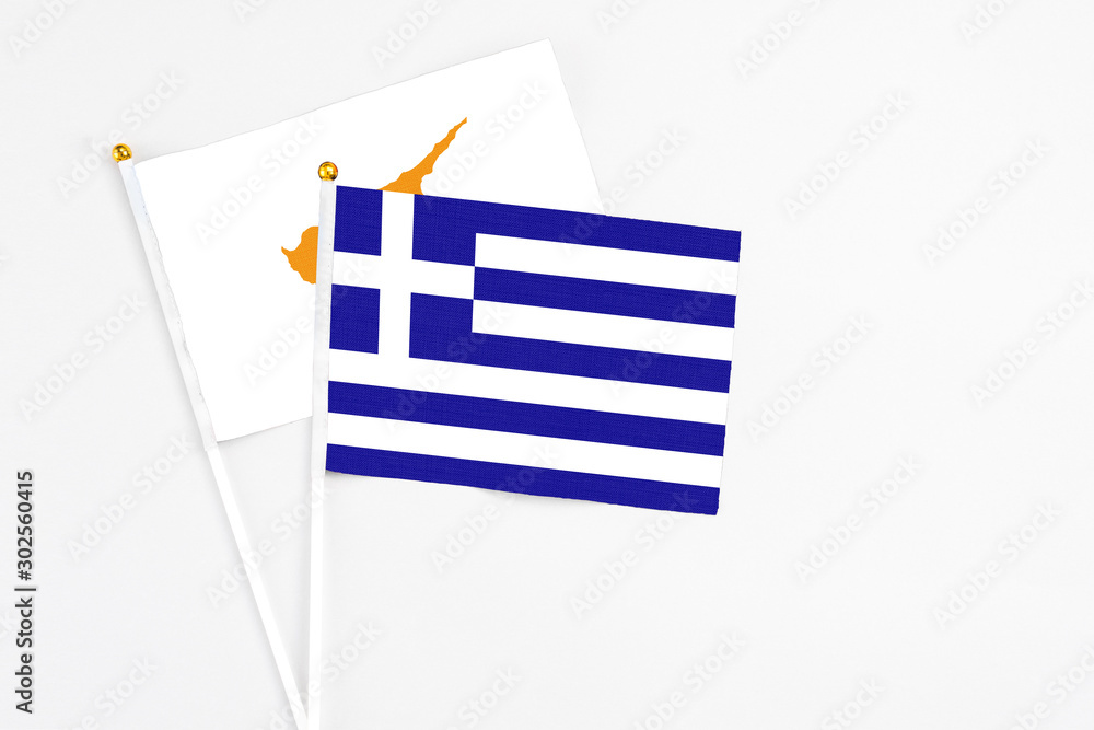 Obraz premium Greece and Cyprus stick flags on white background. High quality fabric, miniature national flag. Peaceful global concept.White floor for copy space.