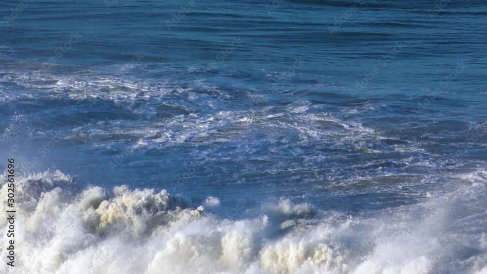 Slow motion large waves crest and crash into the rugged ocean shoreline of the Pacific Ocean. Slow motion large waves crest and crash into the rugged ocean shoreline of the Pacific Ocean.