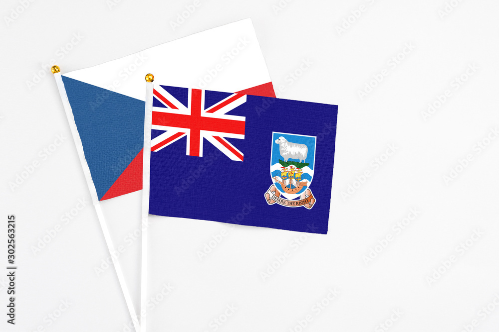 Fototapeta premium Falkland Islands and Cyprus stick flags on white background. High quality fabric, miniature national flag. Peaceful global concept.White floor for copy space.