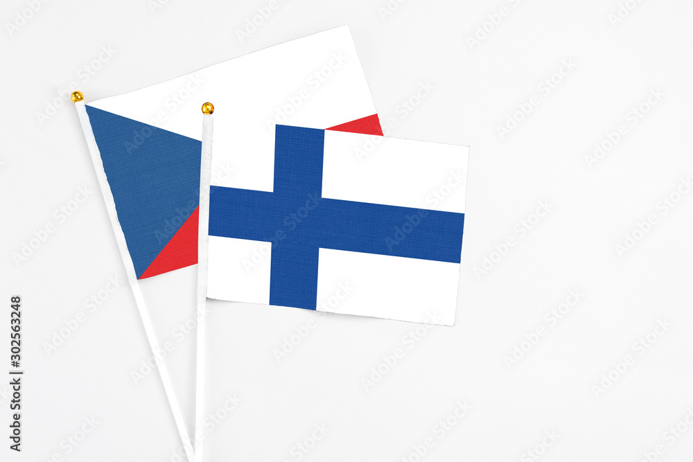 Finland and Cyprus stick flags on white background. High quality fabric, miniature national flag. Peaceful global concept.White floor for copy space.