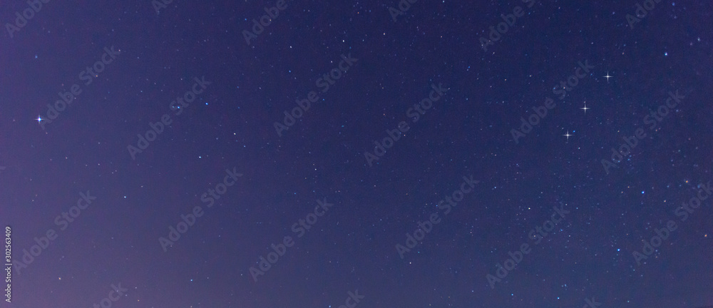 Fototapeta premium Panorama blue night sky milky way and star on dark background.Universe filled with stars, nebula and galaxy with noise and grain.Photo by long exposure and select white balance.selection focus.amazing