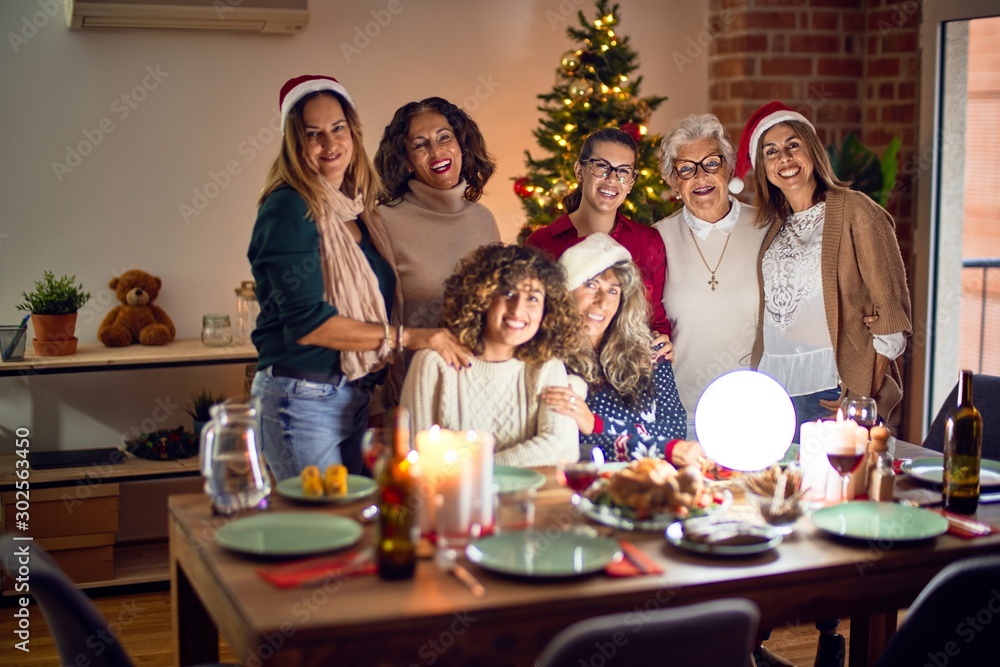 Beautiful group of women smiling happy and confident. Posing around christmas tree at home