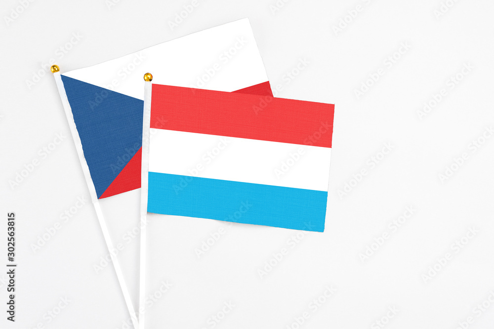 Luxembourg and Cyprus stick flags on white background. High quality fabric, miniature national flag. Peaceful global concept.White floor for copy space. Luxembourg and Cyprus stick flags on white background. High quality fabric, miniature national flag. Peaceful global concept.White floor for copy space.