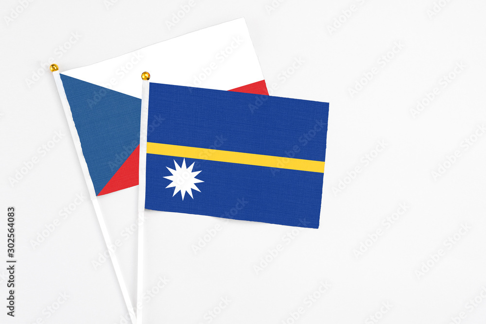 Nauru and Cyprus stick flags on white background. High quality fabric, miniature national flag. Peaceful global concept.White floor for copy space. Nauru and Cyprus stick flags on white background. High quality fabric, miniature national flag. Peaceful global concept.White floor for copy space.