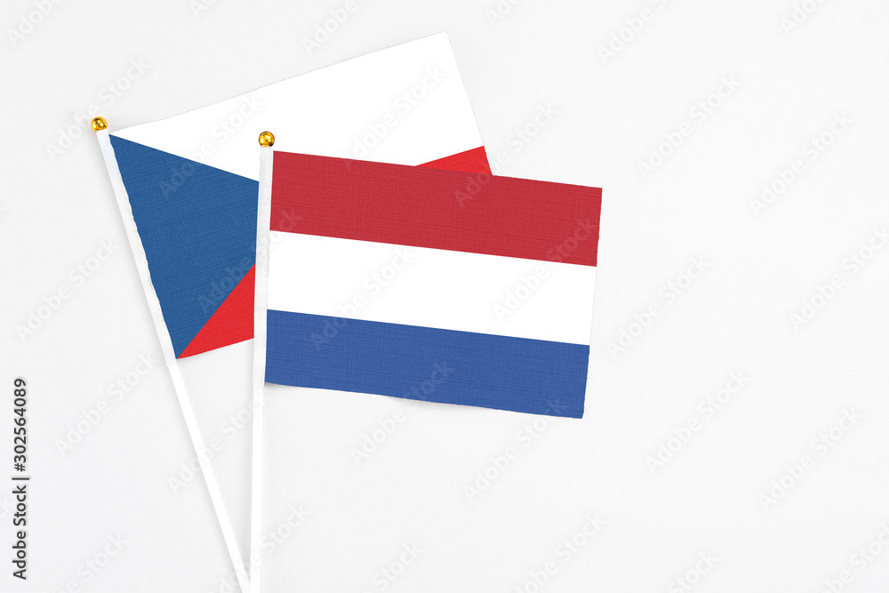 Netherlands and Cyprus stick flags on white background. High quality fabric, miniature national flag. Peaceful global concept.White floor for copy space. Netherlands and Cyprus stick flags on white background. High quality fabric, miniature national flag. Peaceful global concept.White floor for copy space.