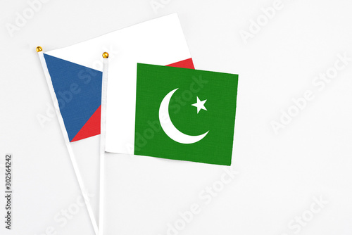 Pakistan and Cyprus stick flags on white background. High quality fabric, miniature national flag. Peaceful global concept.White floor for copy space.