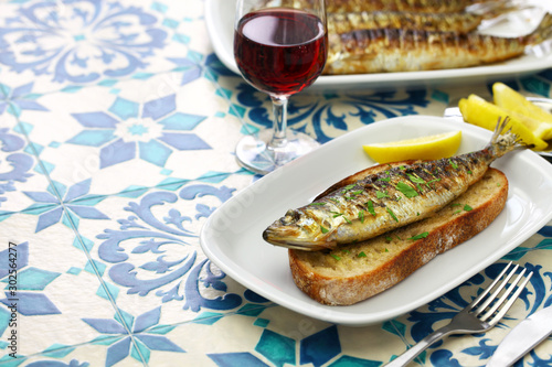 sardinhas assadas, portuguese grilled sardine on toasted bread photo