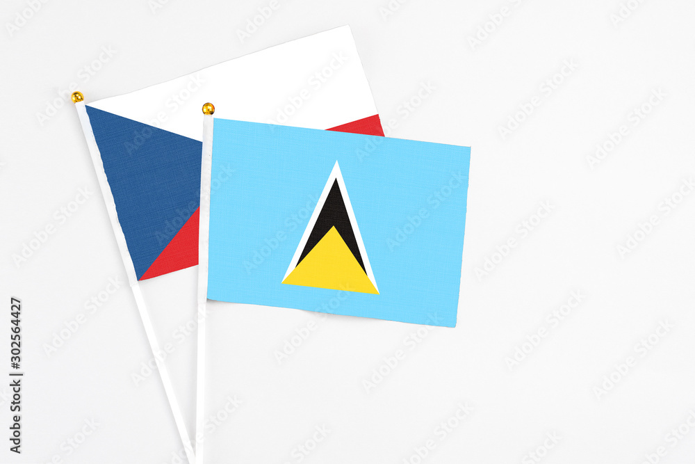 Saint Lucia and Cyprus stick flags on white background. High quality fabric, miniature national flag. Peaceful global concept.White floor for copy space. Saint Lucia and Cyprus stick flags on white background. High quality fabric, miniature national flag. Peaceful global concept.White floor for copy space.