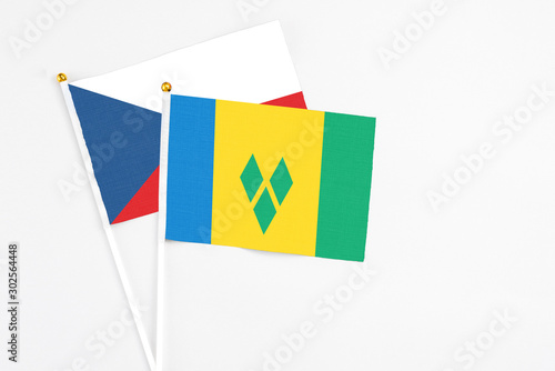 Saint Vincent And The Grenadines and Cyprus stick flags on white background. High quality fabric, miniature national flag. Peaceful global concept.White floor for copy space.