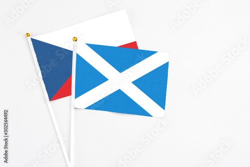 Scotland and Cyprus stick flags on white background. High quality fabric, miniature national flag. Peaceful global concept.White floor for copy space.