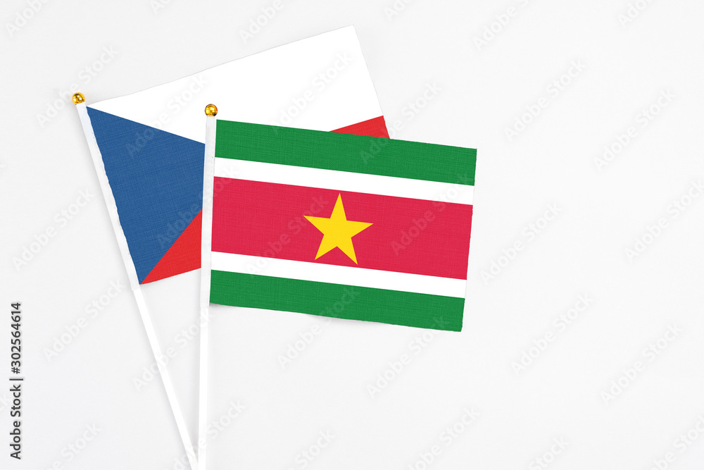 Suriname and Cyprus stick flags on white background. High quality fabric, miniature national flag. Peaceful global concept.White floor for copy space. Suriname and Cyprus stick flags on white background. High quality fabric, miniature national flag. Peaceful global concept.White floor for copy space.