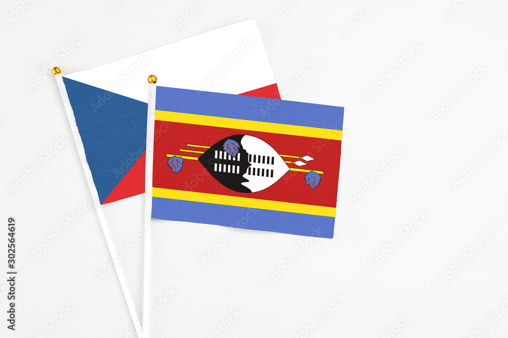 Swaziland and Cyprus stick flags on white background. High quality fabric, miniature national flag. Peaceful global concept.White floor for copy space. Swaziland and Cyprus stick flags on white background. High quality fabric, miniature national flag. Peaceful global concept.White floor for copy space.
