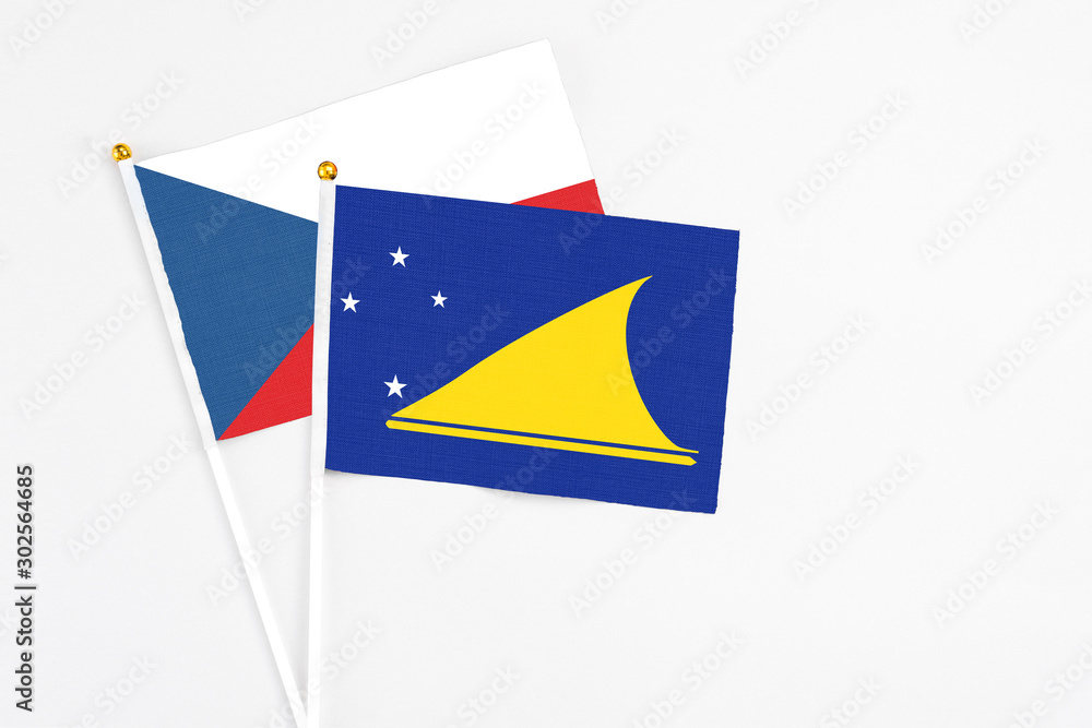 Tokelau and Cyprus stick flags on white background. High quality fabric, miniature national flag. Peaceful global concept.White floor for copy space. Tokelau and Cyprus stick flags on white background. High quality fabric, miniature national flag. Peaceful global concept.White floor for copy space.