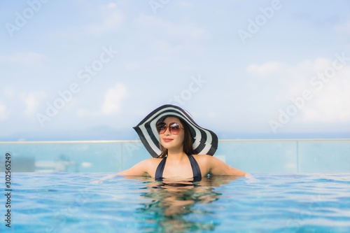 Portrait beautiful young asian women happy smile relax outdoor swimming pool in resort © siraphol