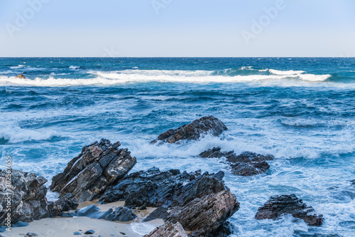 Beach Rocks and blue waves on Jeongdong Simgok Sea Fan Road, East sea of South Korea