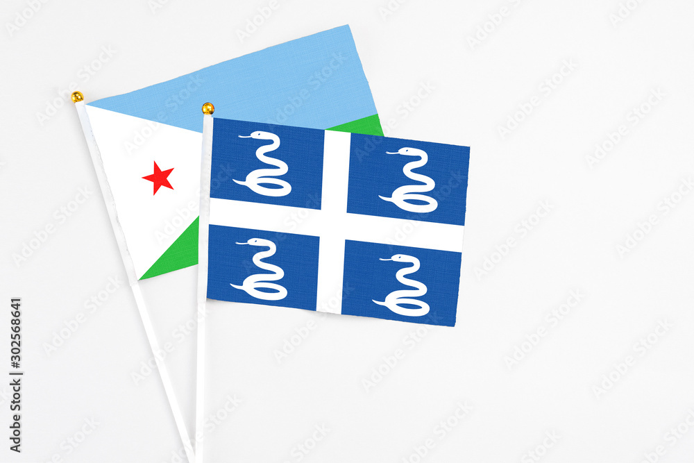 Martinique and Djibouti stick flags on white background. High quality fabric, miniature national flag. Peaceful global concept.White floor for copy space. Martinique and Djibouti stick flags on white background. High quality fabric, miniature national flag. Peaceful global concept.White floor for copy space.