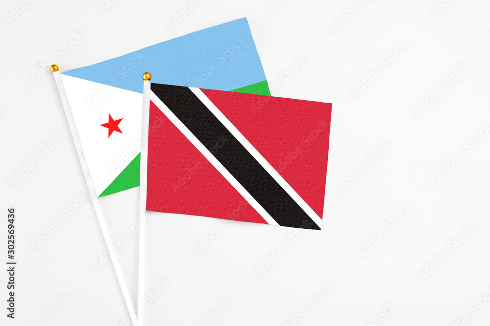 Trinidad And Tobago and Djibouti stick flags on white background. High quality fabric, miniature national flag. Peaceful global concept.White floor for copy space. Trinidad And Tobago and Djibouti stick flags on white background. High quality fabric, miniature national flag. Peaceful global concept.White floor for copy space.