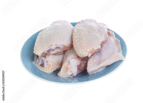 Raw chicken on cutting board on white background