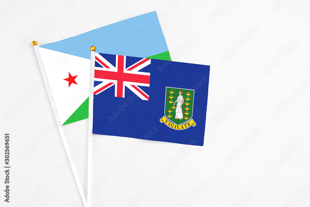 Fototapeta premium British Virgin Islands and Djibouti stick flags on white background. High quality fabric, miniature national flag. Peaceful global concept.White floor for copy space.