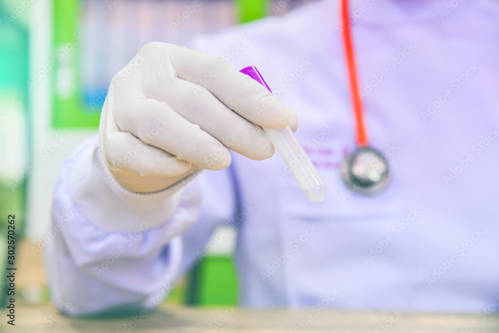 Health care.Healthy.science, chemistry, biology, medicine and people concept. close up of doctor holding test tube with blood sample making research in clinical laboratory. Health care.Healthy.science, chemistry, biology, medicine and people concept. close up of doctor holding test tube with blood sample making research in clinical laboratory.