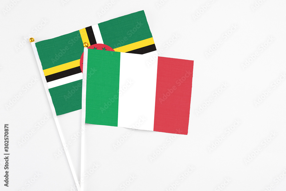 Italy and Dominica stick flags on white background. High quality fabric, miniature national flag. Peaceful global concept.White floor for copy space. Italy and Dominica stick flags on white background. High quality fabric, miniature national flag. Peaceful global concept.White floor for copy space.