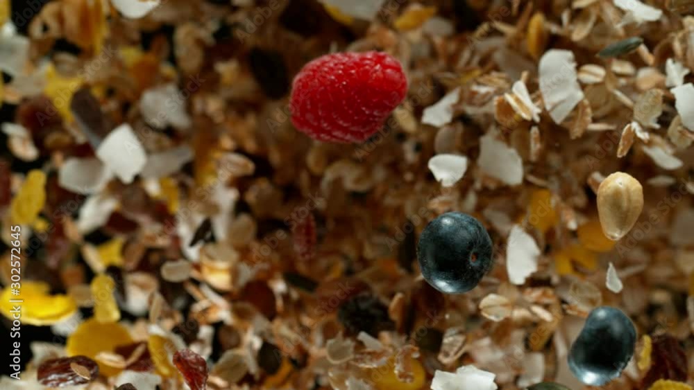 Super slow motion of flying group of cereal muesli pieces. Filmed on high speed cinema camera, 1000fps. Super slow motion of flying group of cereal muesli pieces. Filmed on high speed cinema camera, 1000fps.