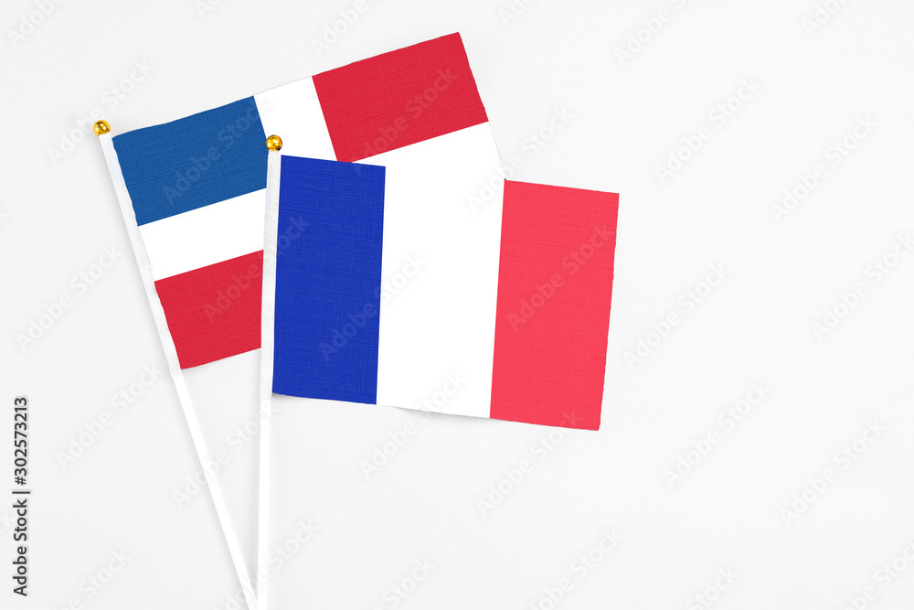 France and Dominican Republic stick flags on white background. High quality fabric, miniature national flag. Peaceful global concept.White floor for copy space. France and Dominican Republic stick flags on white background. High quality fabric, miniature national flag. Peaceful global concept.White floor for copy space.