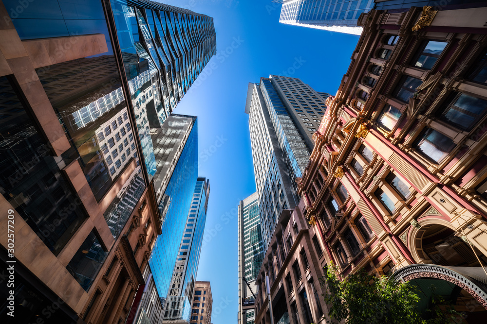 Naklejka premium Soaring Dynamic Towers perspective on a major street in Sydney City in Australia.