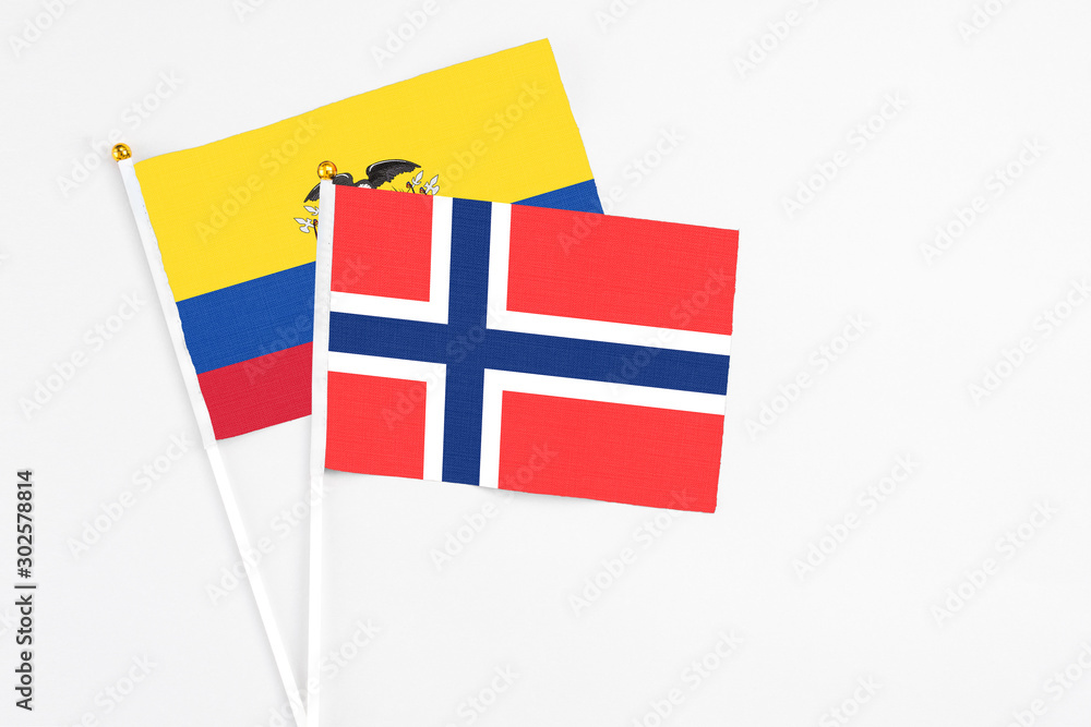 Bouvet Islands and Ecuador stick flags on white background. High quality fabric, miniature national flag. Peaceful global concept.White floor for copy space.