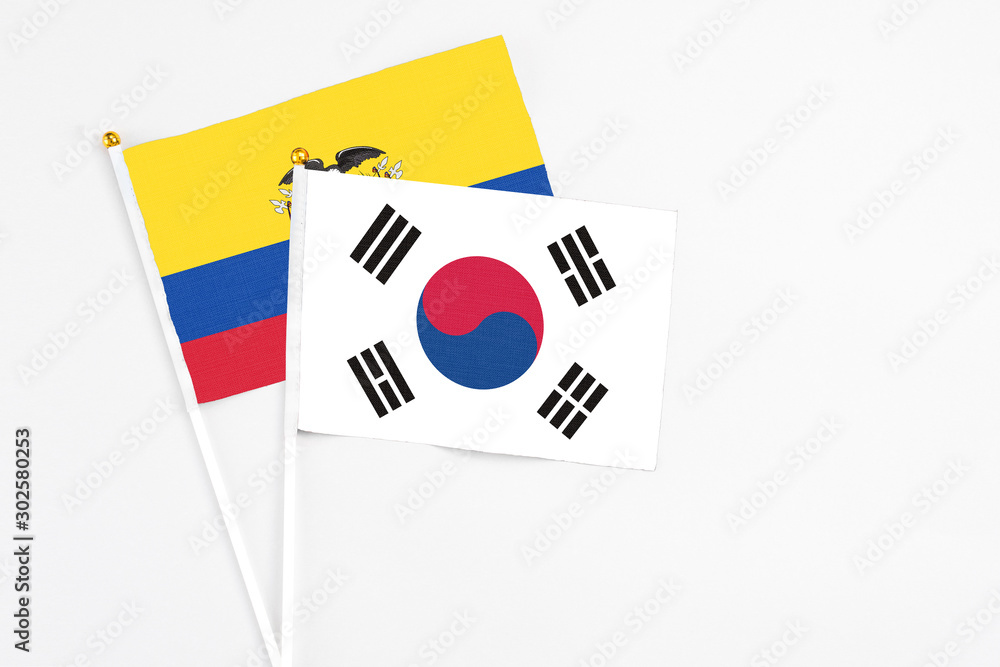 South Korea and Ecuador stick flags on white background. High quality fabric, miniature national flag. Peaceful global concept.White floor for copy space.
