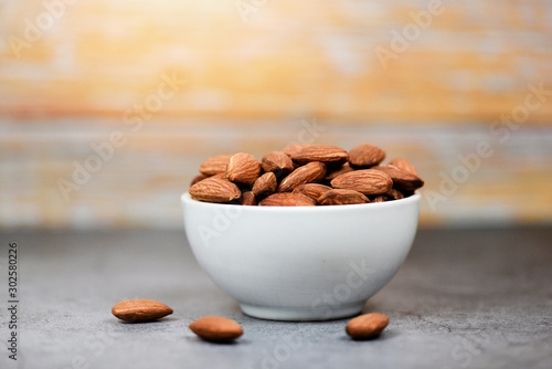 Almonds bowl on wood background / Close up almond nuts natural protein food and for snack