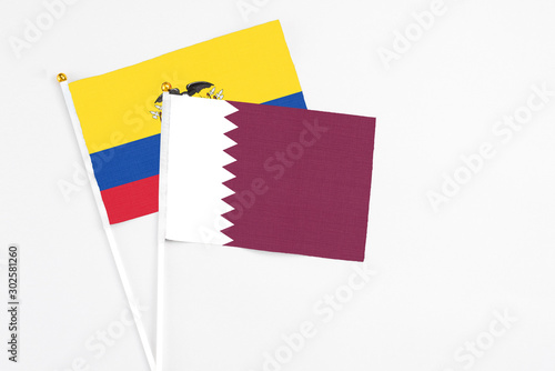 Qatar and Ecuador stick flags on white background. High quality fabric, miniature national flag. Peaceful global concept.White floor for copy space.