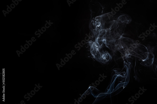 Abstract smoke swirls on black