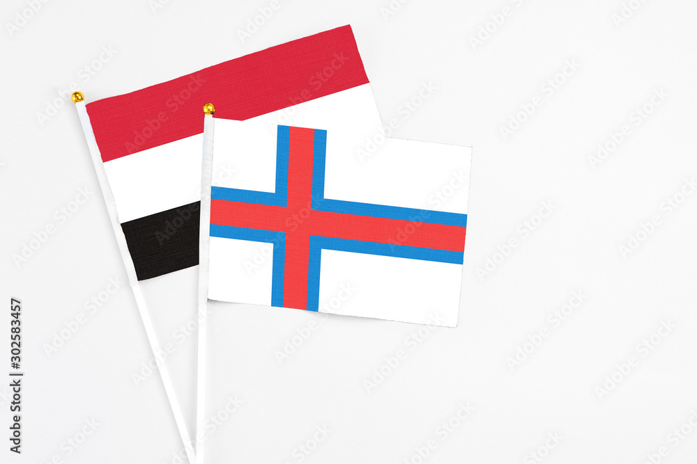 Faroe Islands and Egypt stick flags on white background. High quality fabric, miniature national flag. Peaceful global concept.White floor for copy space.
