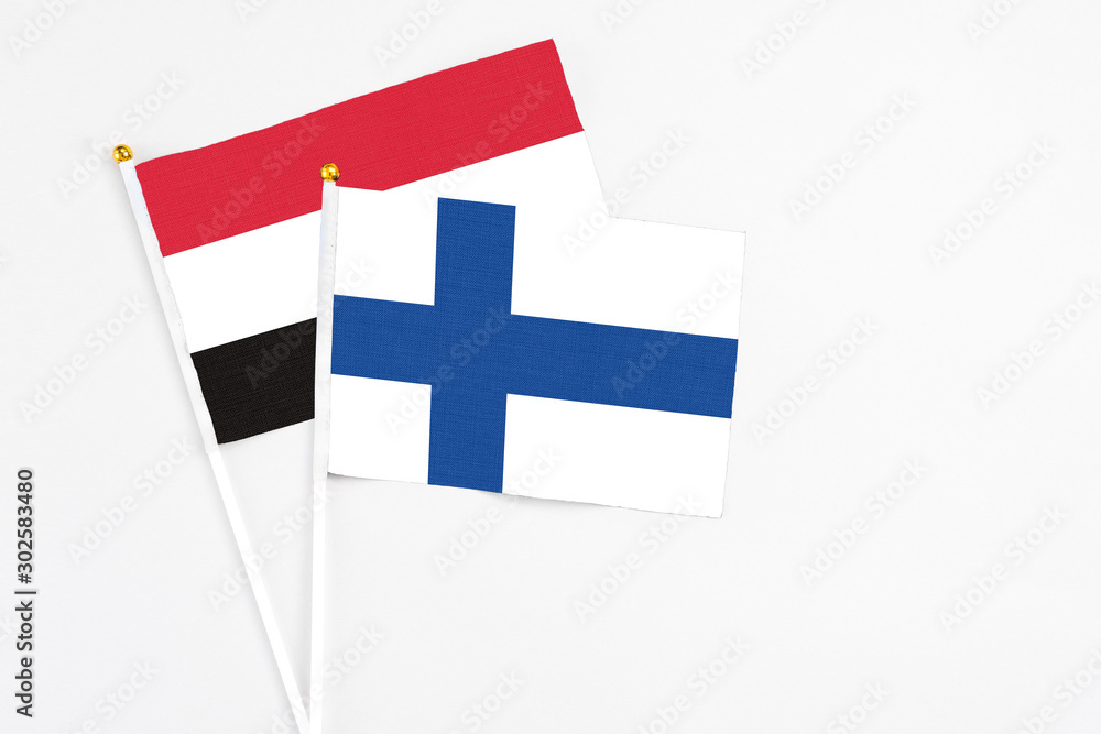 Finland and Egypt stick flags on white background. High quality fabric, miniature national flag. Peaceful global concept.White floor for copy space.
