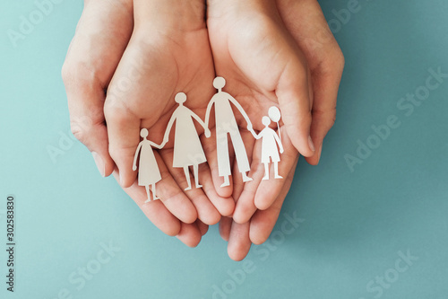 Fotografie hands holding paper family cutout, family home, adoption foster care, homeless c