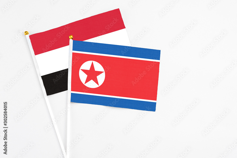 North Korea and Egypt stick flags on white background. High quality fabric, miniature national flag. Peaceful global concept.White floor for copy space. North Korea and Egypt stick flags on white background. High quality fabric, miniature national flag. Peaceful global concept.White floor for copy space.
