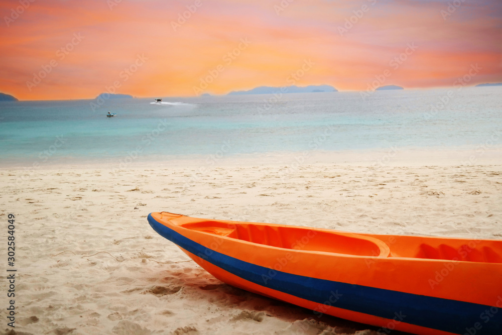 orange kayak boat on beach